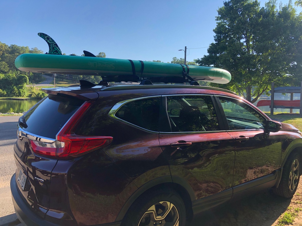 roof rack with paddle board on SUV